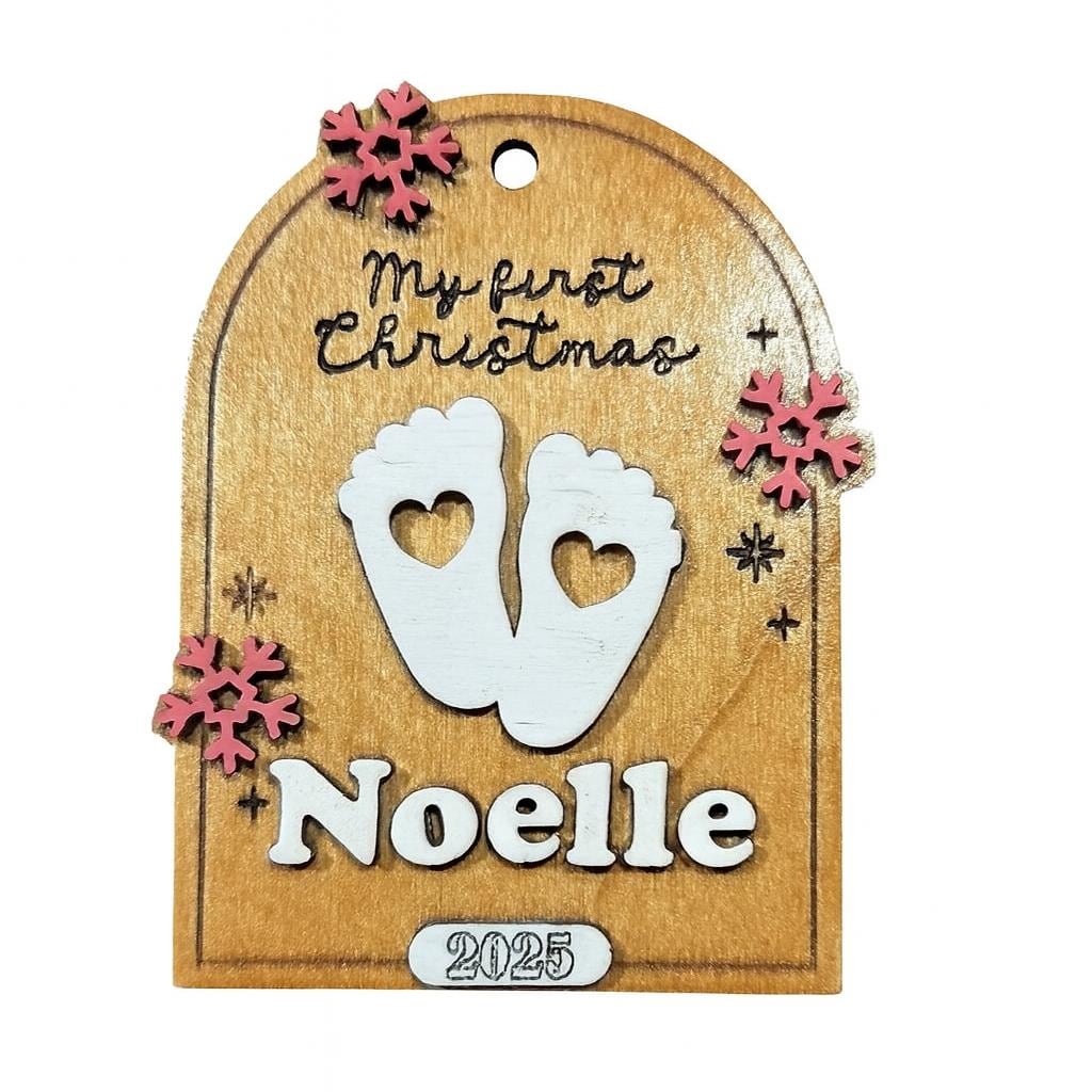 Baby’s First Christmas ornament with baby feet and name, shown in a styled setting